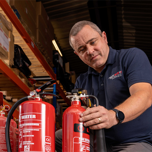 Right Action engineer commissioning a fire extinguisher Right Action engineer commissioning a fire extinguisher