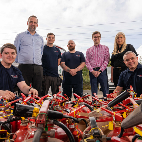 The Right Action Team, in front of a set of Fire Extinguishers The Right Action Team, in front of a set of Fire Extinguishers