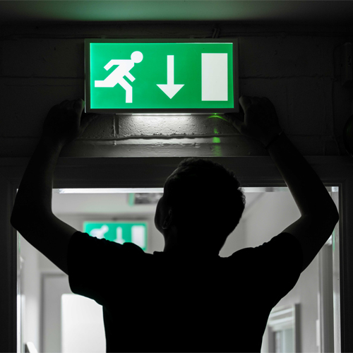 Emergency lighting engineer fitting emergency light