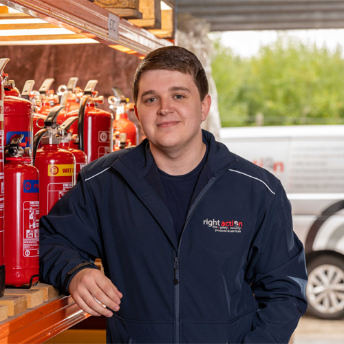 Jake from Right Action stood in front of Fire Extinguishers