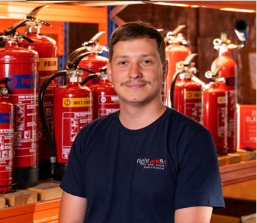 Andy from Right Action stood in front of Fire Extinguishers